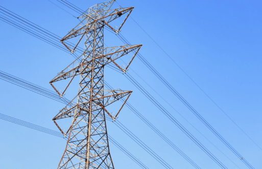 Transmission lines against a bright blue sky