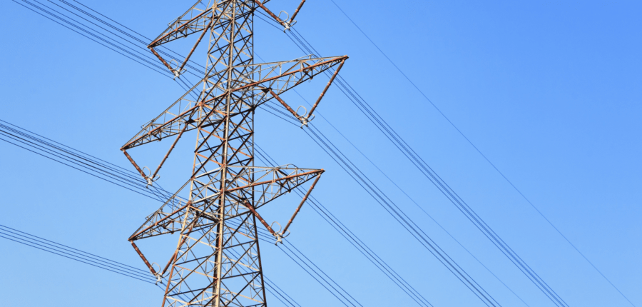 Transmission lines against a bright blue sky