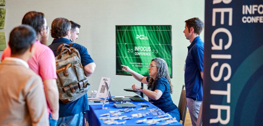 PCI's Daphne Thompson, brand marketer, and David Christopher, senior director of marketing, help INFOCUS 2023 attendees check into the conference at the Omni Oklahoma City Hotel.