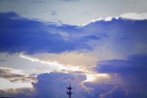 clouds and transmission tower