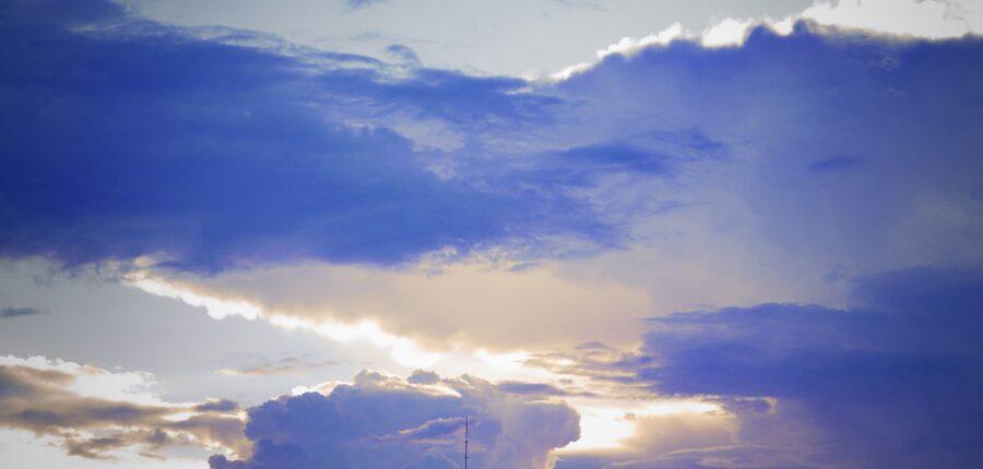 clouds and transmission tower